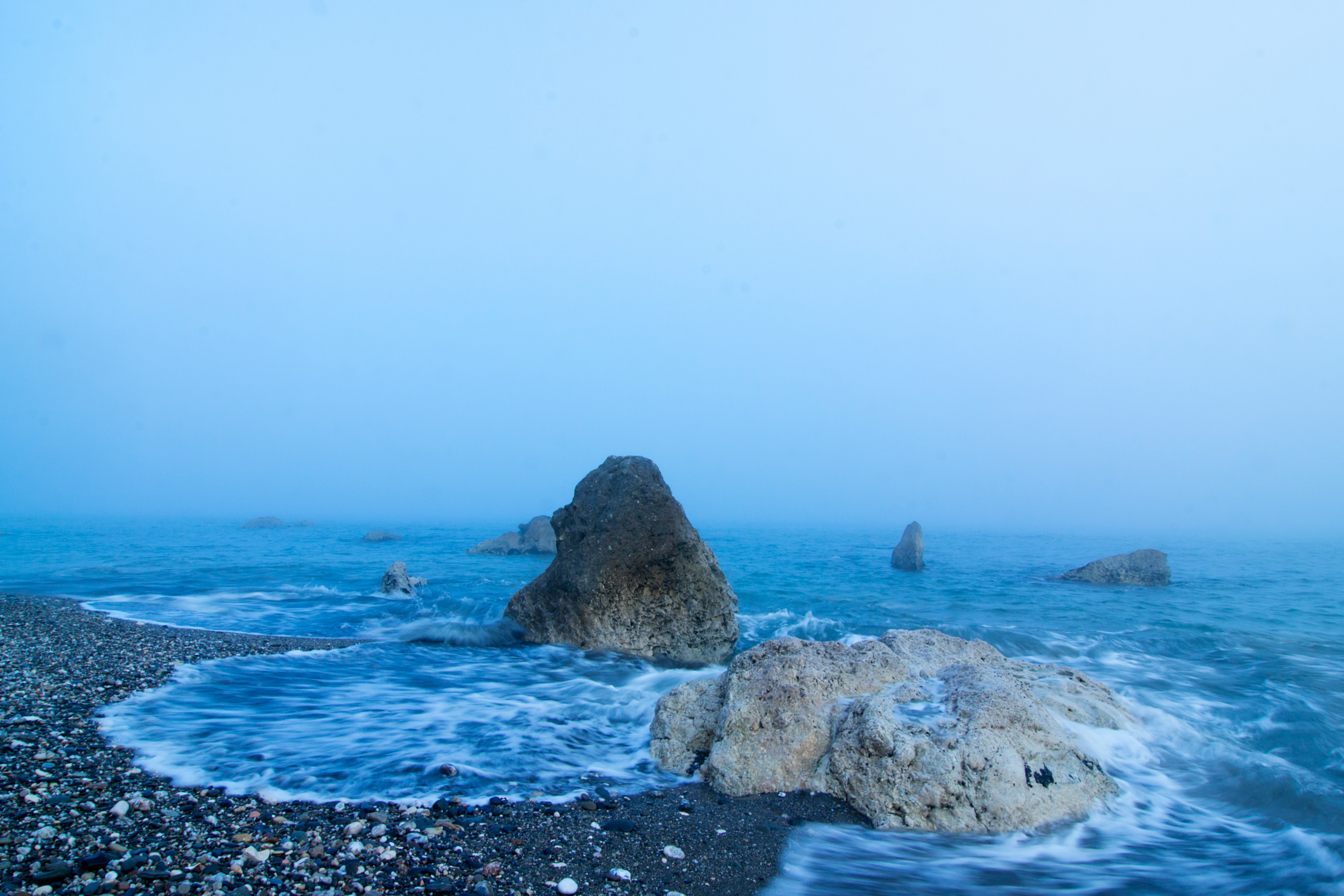 gray rock formation on sea during daytime